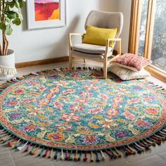 a living room with a large rug and chair next to a potted plant on the floor