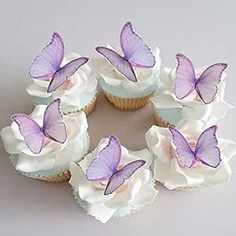 several cupcakes with purple butterflies on them