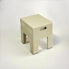 a small white stool sitting on top of a white floor