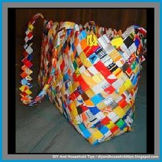 a multicolored woven bag sitting on top of a black cloth covered tablecloth