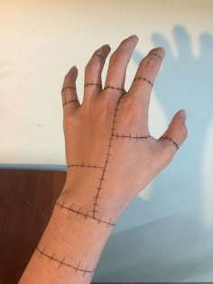 a person's hand with cross marks on it