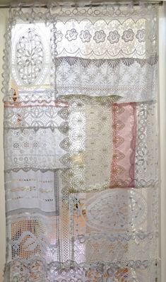 the window is covered in lace and crochet