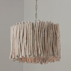 a light fixture made out of driftwood sticks