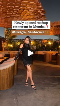 a woman standing in front of a bar with the caption, newly opened rooftop restaurant in munnai