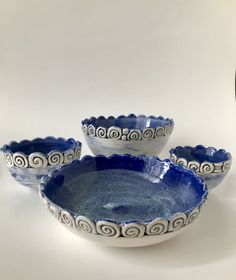 three blue and white bowls sitting next to each other