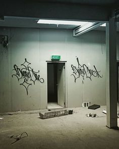 an empty room with graffiti on the walls