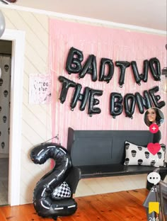 a room decorated with balloons and heliums that read, badtin'the bone