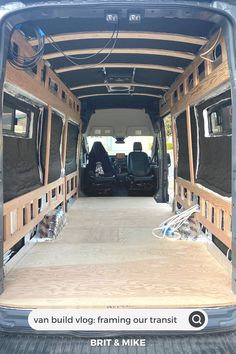 the back end of a van with its doors open and wood flooring in place