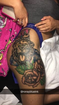 a woman with a tiger tattoo on her thigh