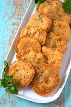 some fried food on a white plate with parsley