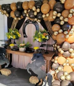 a table with balloons and decorations on it