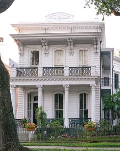 a large white house with many windows and balconies