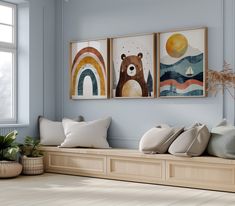 three framed pictures hang on the wall above a bench in a room with blue walls