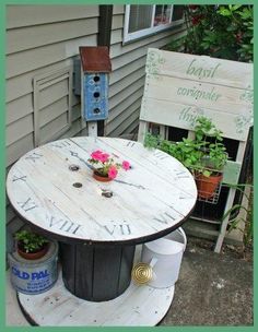 an outdoor table and chair made out of pallet wood with flowers on the table