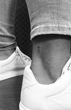 a person with a cross tattoo on their foot and the caption reads, c's jonboys p'on instagram