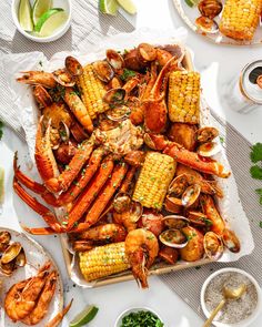 lobsters, corn on the cob and clams are served in trays