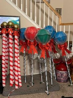 candy canes are wrapped in red, white and blue paper for christmas decorations on the banister