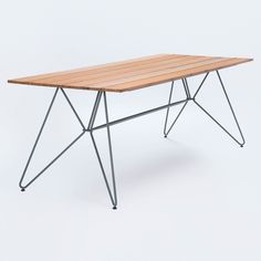 a wooden table with metal legs on a white background