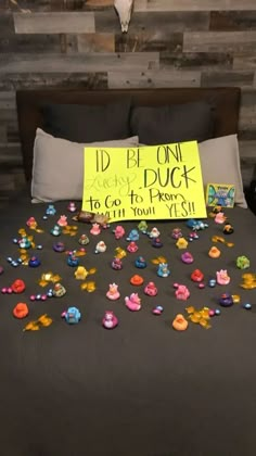 a bed topped with lots of little toys and a sign that says i'd be on duck to go to prison