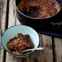 two bowls filled with food sitting on top of a wooden table next to each other