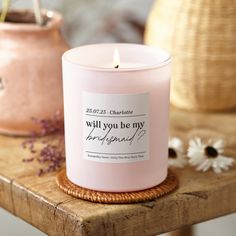 a pink candle sitting on top of a wooden table