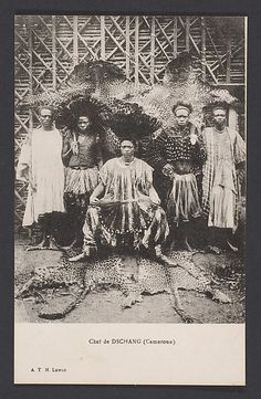 an old black and white photo of people dressed in native garb standing next to each other