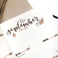 a notebook with the word september written in cursive writing