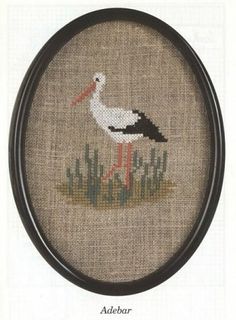 a cross stitch pattern with a stork on it