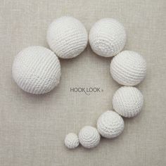 white crocheted balls arranged in the shape of a circle on a beige background