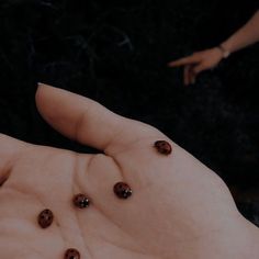 two hands are shown with brown buttons on them