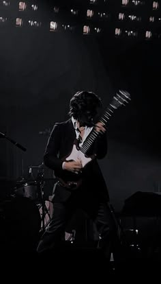 a man playing an electric guitar on stage