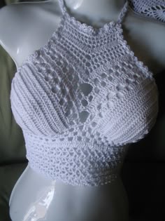 a white crocheted top on a mannequin