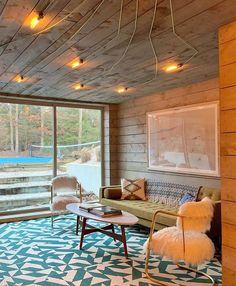 a living room filled with furniture next to a large sliding glass door that opens onto a deck