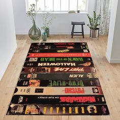 a large rug with various movie titles on it in a room next to a window