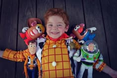 a young boy with his arms around toy characters