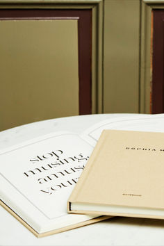 two books sitting on top of a white table