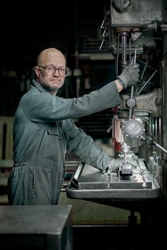 a man working on a machine in a factory