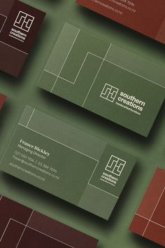 several business cards are arranged on top of each other, with different colors and shapes