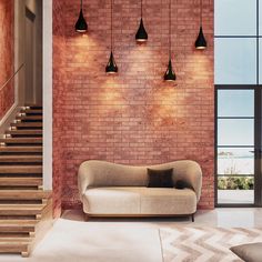 a living room with red brick walls and stairs