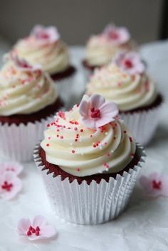 cupcakes with white frosting and pink sprinkles