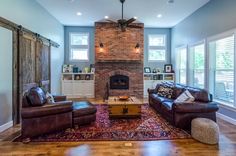 a living room filled with furniture and a fire place