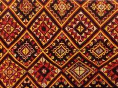 an old red and yellow cloth with geometric designs