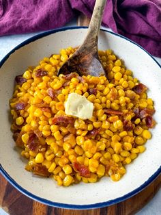 a white bowl filled with corn and bacon