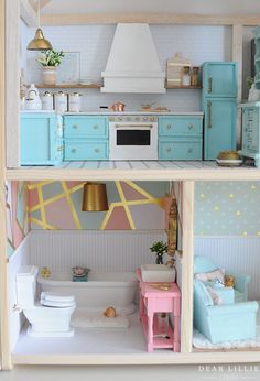 a dollhouse kitchen with blue cabinets and pink furniture on the shelves, including a white stove top oven