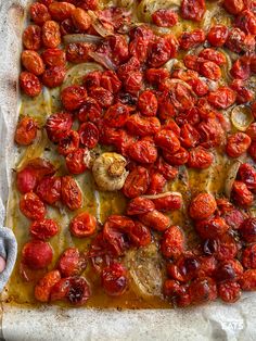 an uncooked pizza topped with tomatoes and mushrooms