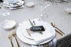 a table set with place settings and silverware