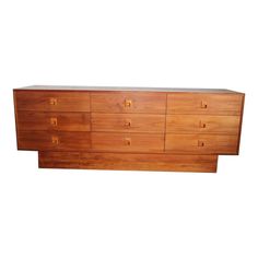 a large wooden dresser sitting on top of a white wall