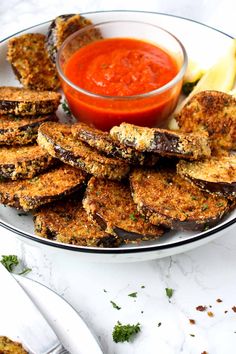 some fried food on a plate with dipping sauce