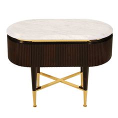 a table with a white marble top and gold trimmings on the bottom,