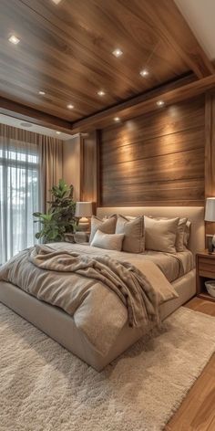 a large bed sitting inside of a bedroom on top of a wooden floor next to a window